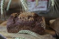 Whole and sliced Ã¢â¬â¹Ã¢â¬â¹rye bread and ears of rye in a basket with the inscription HOME on a wooden rustic background Royalty Free Stock Photo